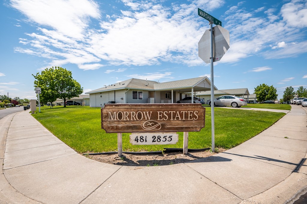 a street sign for morrow estates in front of a house