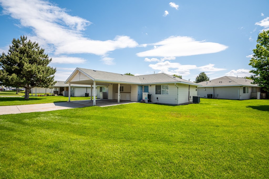 a white house with a yard in front of it