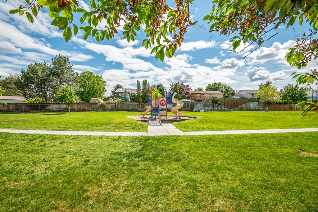 a park with a playground and a statue in the middle