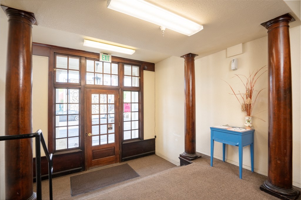 a lobby with two doors and a blue table