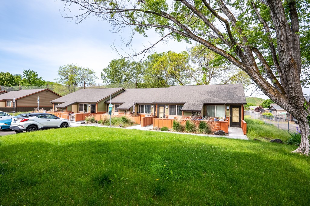 a house with a yard and a parking lot