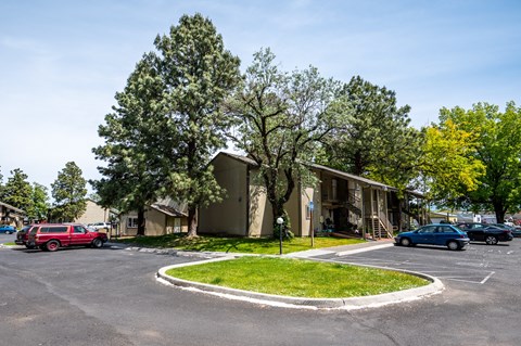 a parking lot with cars parked in front of houses