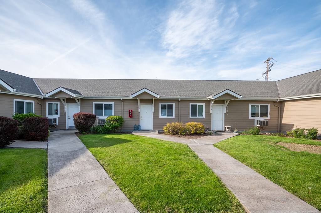 a home with a sidewalk and lawn in front of it