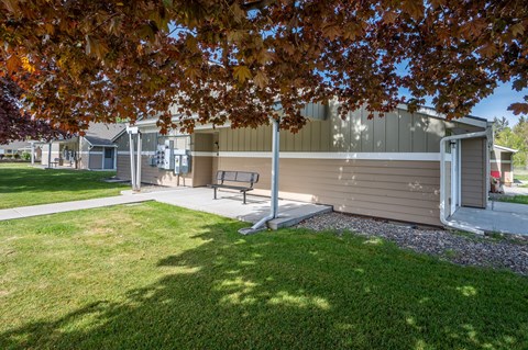 a bench in front of a building with a lawn