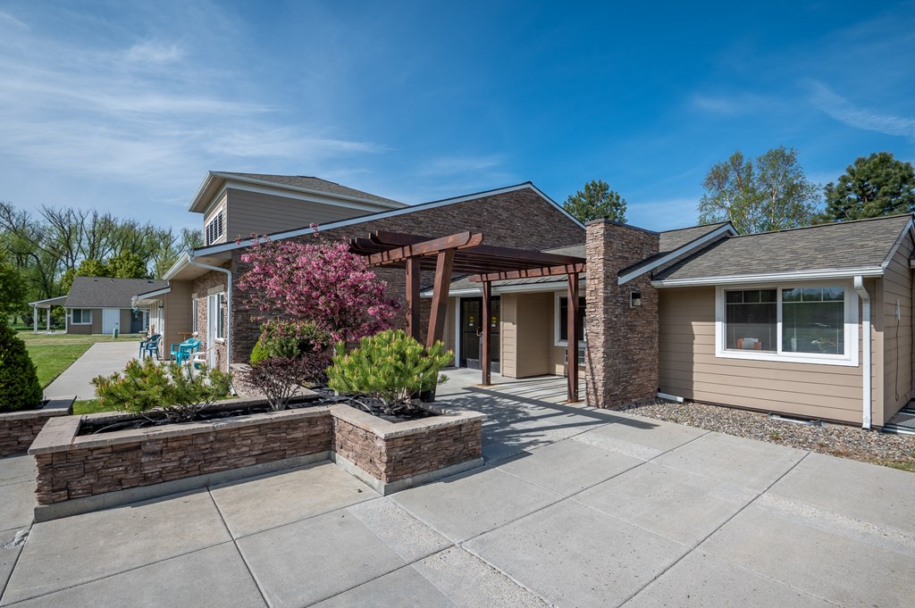 the view of a house with a concrete driveway and a landscaped yard