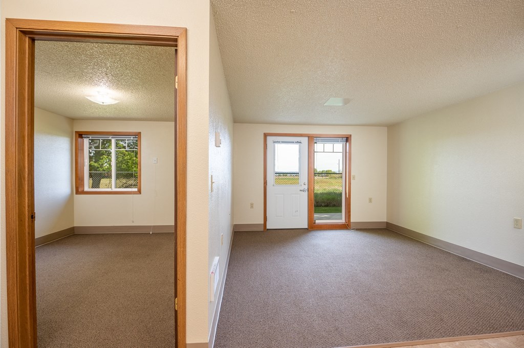 the living room and dining room of an empty house