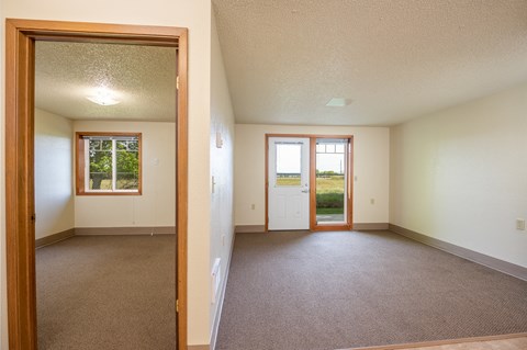 the living room and dining room of an empty house
