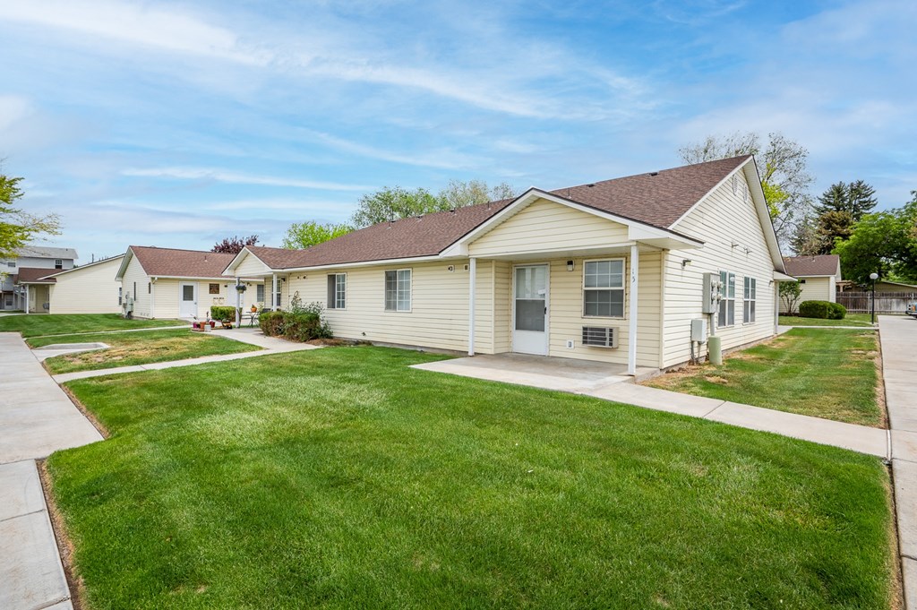 a white house with a yard and a sidewalk