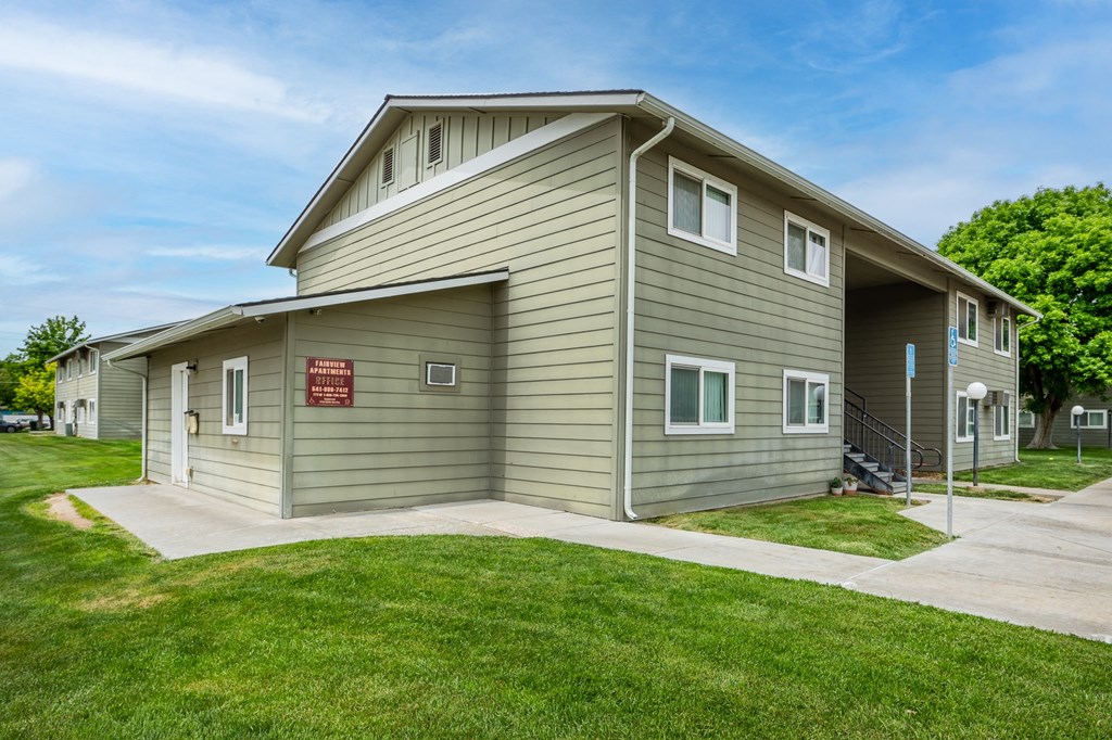 a green house with a sign on the side of it