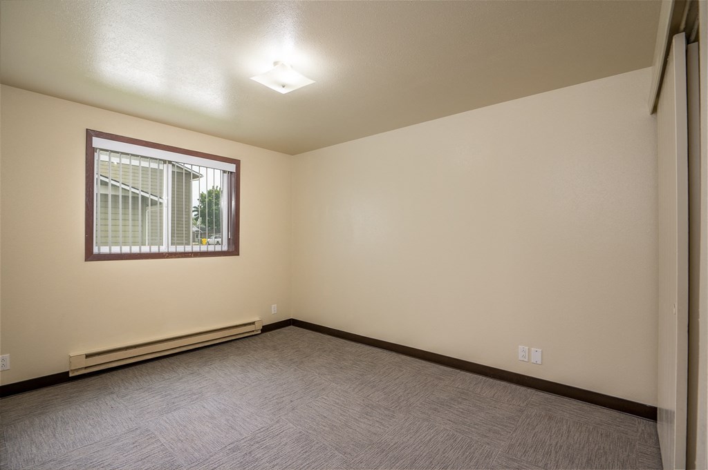 the living room of a home with a carpeted floor and a window