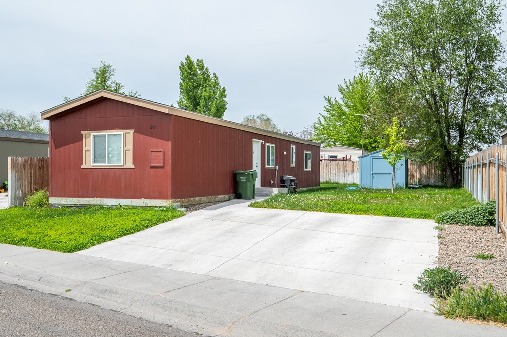 a red house with a driveway in front of it