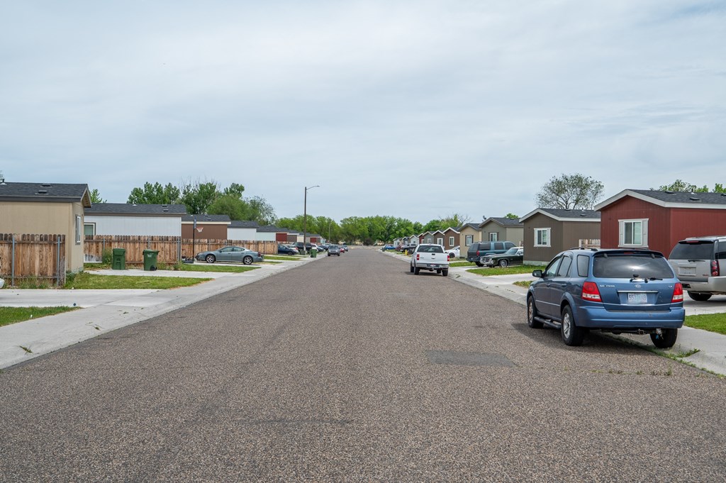 a city street with cars parked on the side of the road