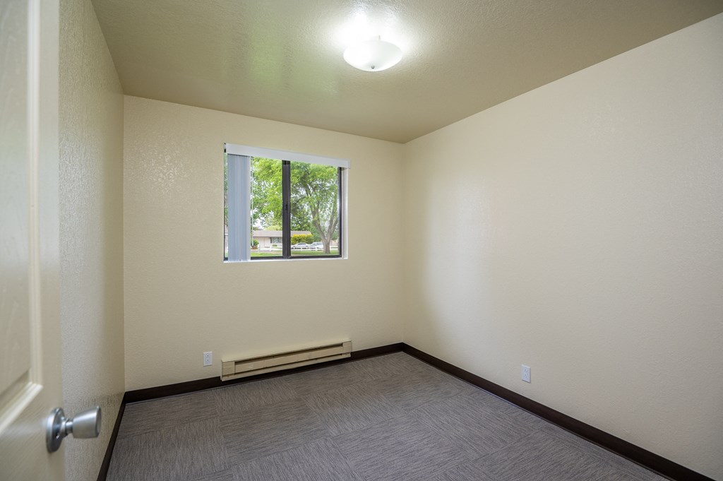 the living room of an empty house with a window