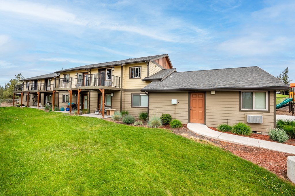 the view of a house with a yard and grass