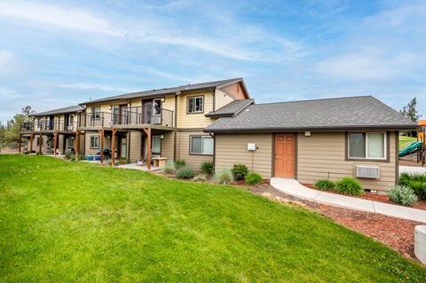 the view of a house with a yard and grass