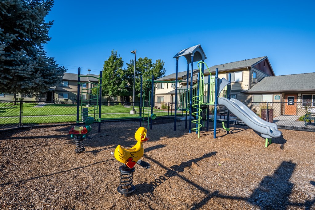 A playground with a yellow rubber ducky toy in the foreground.
