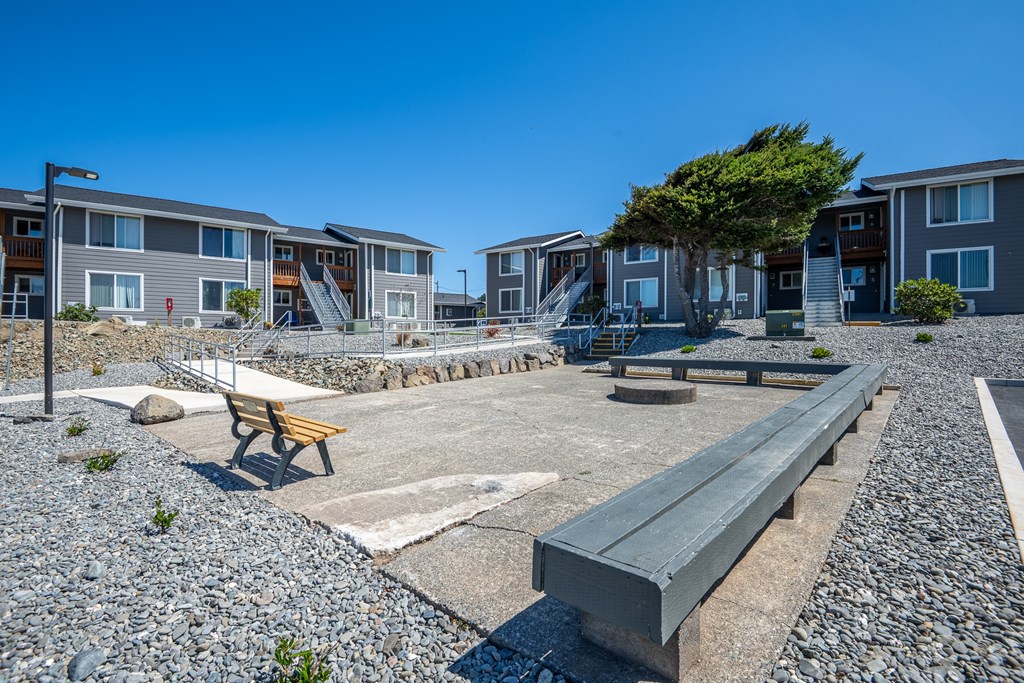 A sunny day at a residential area with a playground and benches.