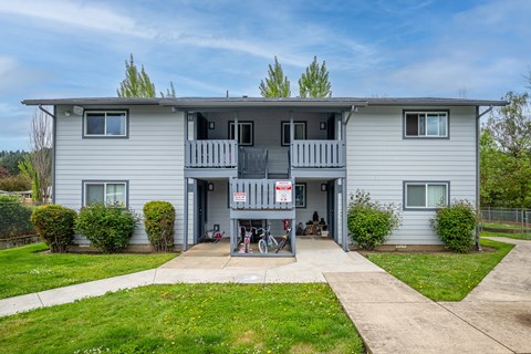A two-story house with a balcony on the second floor.