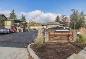a sign in front of a parking lot with houses