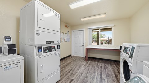 A laundry room with washers and dryers.