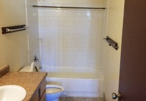 a bathroom with a toilet and a sink and a shower
