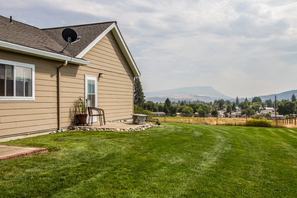 a house with a yard and a view of the mountains