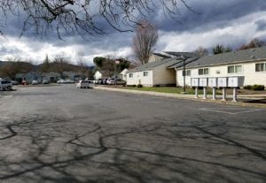 a parking lot in front of a row of houses