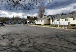a parking lot in front of a row of houses