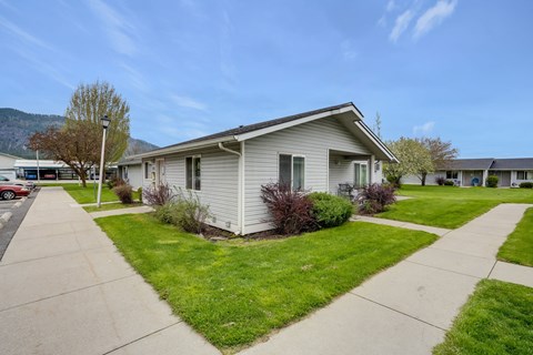 a white house with a sidewalk in front of it