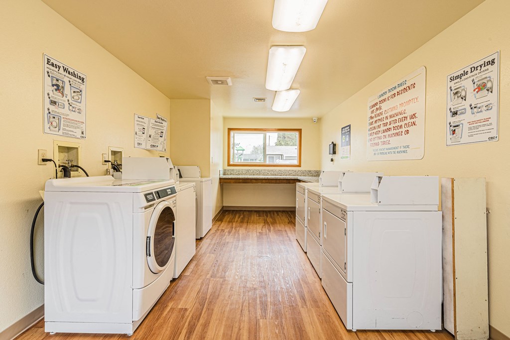A laundry room with washers and dryers.