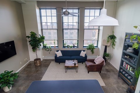A living room with a blue couch and a coffee table.