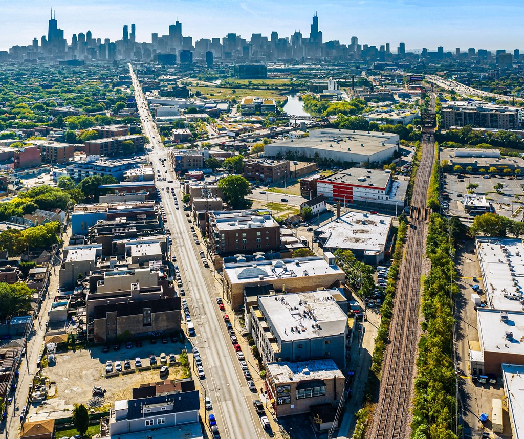 A cityscape with a highway running through the middle of a residential area.