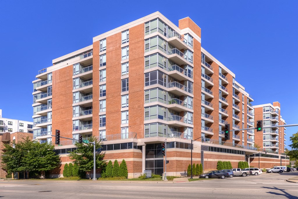 an apartment building on the corner of a city street