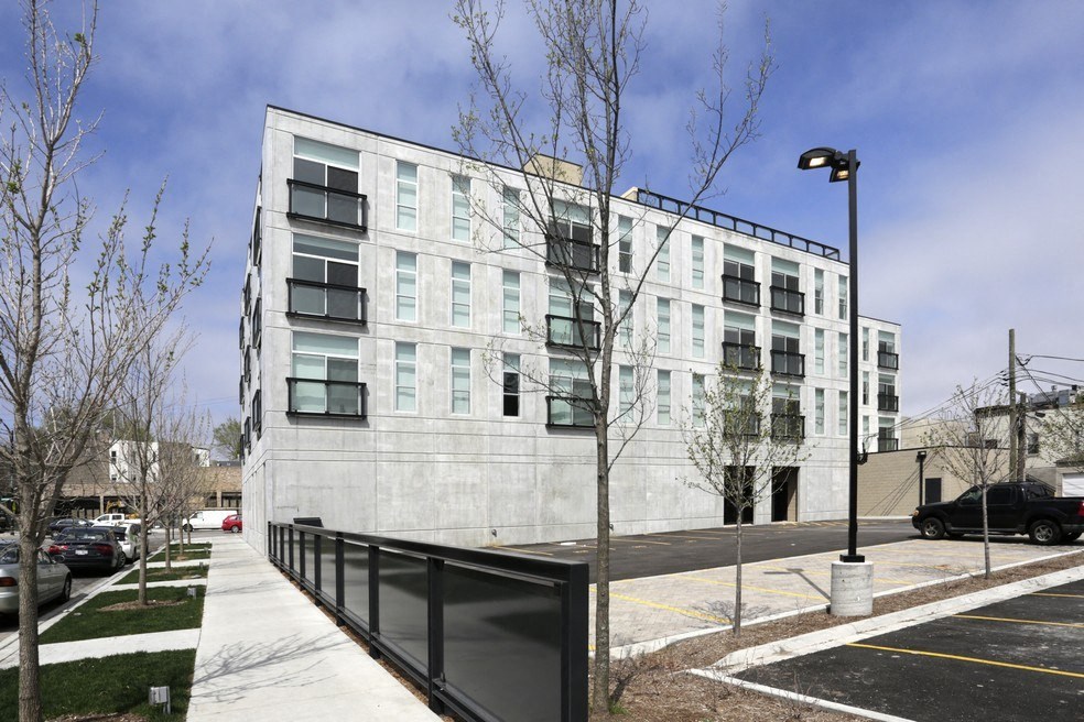 the exterior of an apartment building on a city street