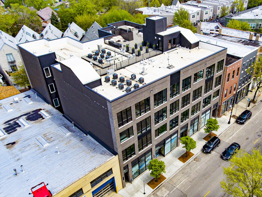 an aerial view of a building with a rooftop parking lot