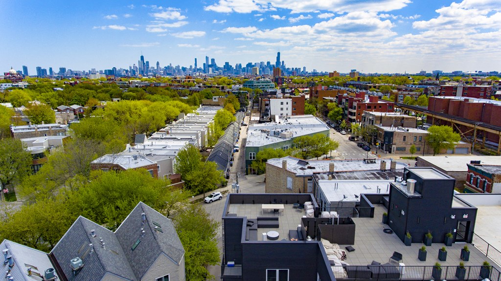an aerial view of a city with the skyline in the background