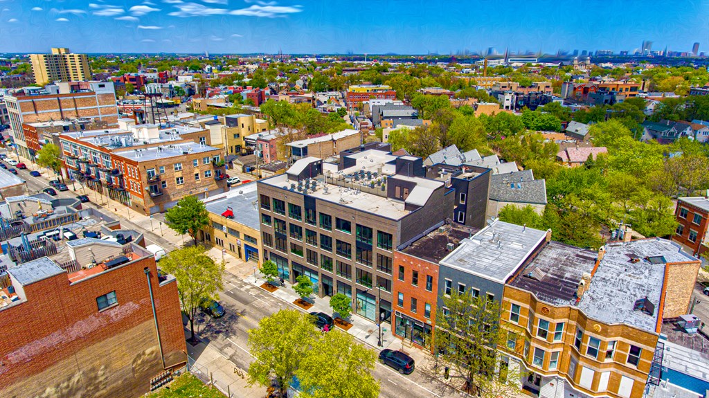 an aerial view of a city with buildings and trees