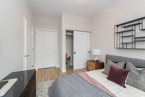a bedroom with a large bed and a mirrored closet