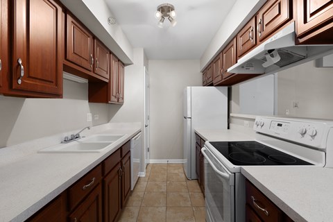 a kitchen with white appliances and wooden cabinets