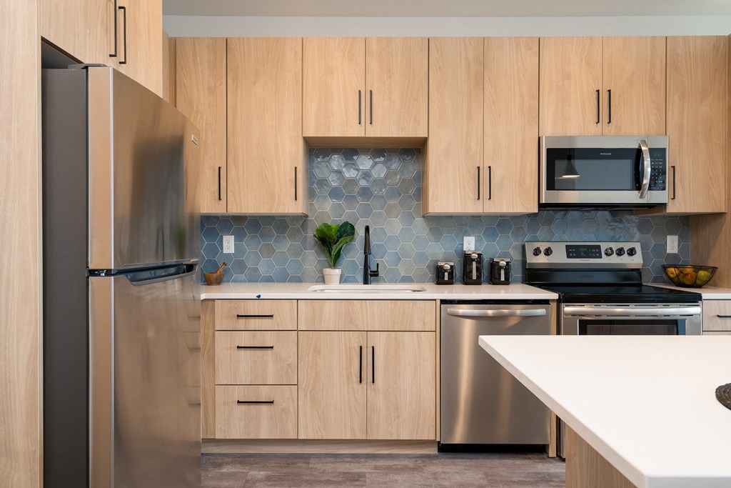 a kitchen with wooden cabinets and stainless steel appliances