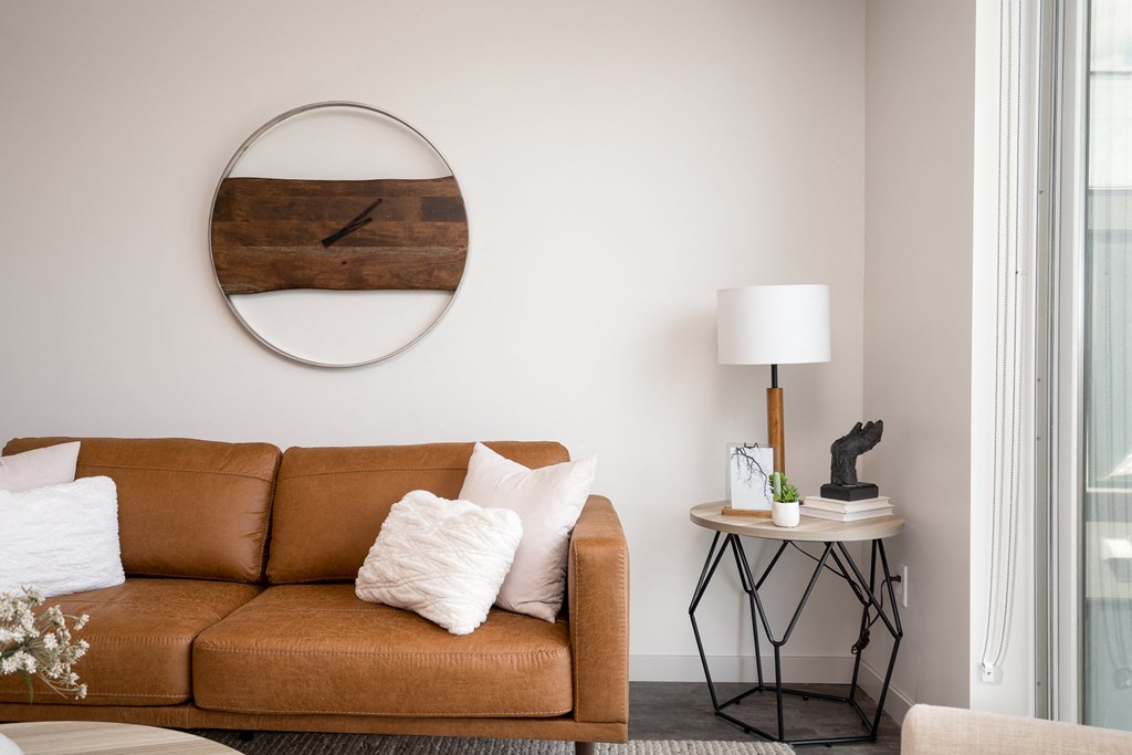 a living room with a couch and a mirror