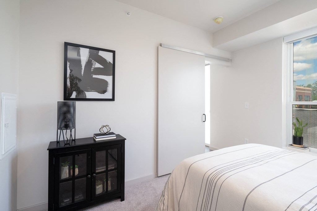 a bedroom with a large bed and a door to a bathroom