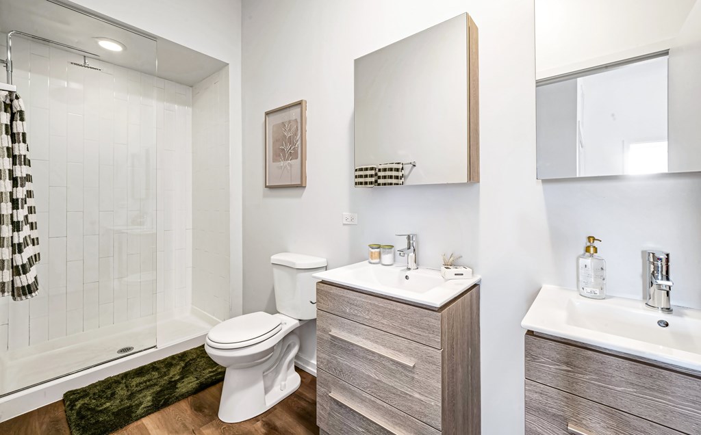 A bathroom with a toilet, sink, and shower.