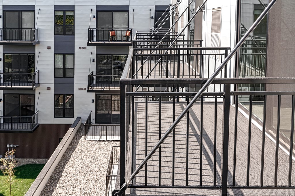 an apartment building with a metal staircase in front of it