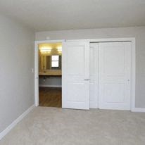 an empty room with two white doors in it