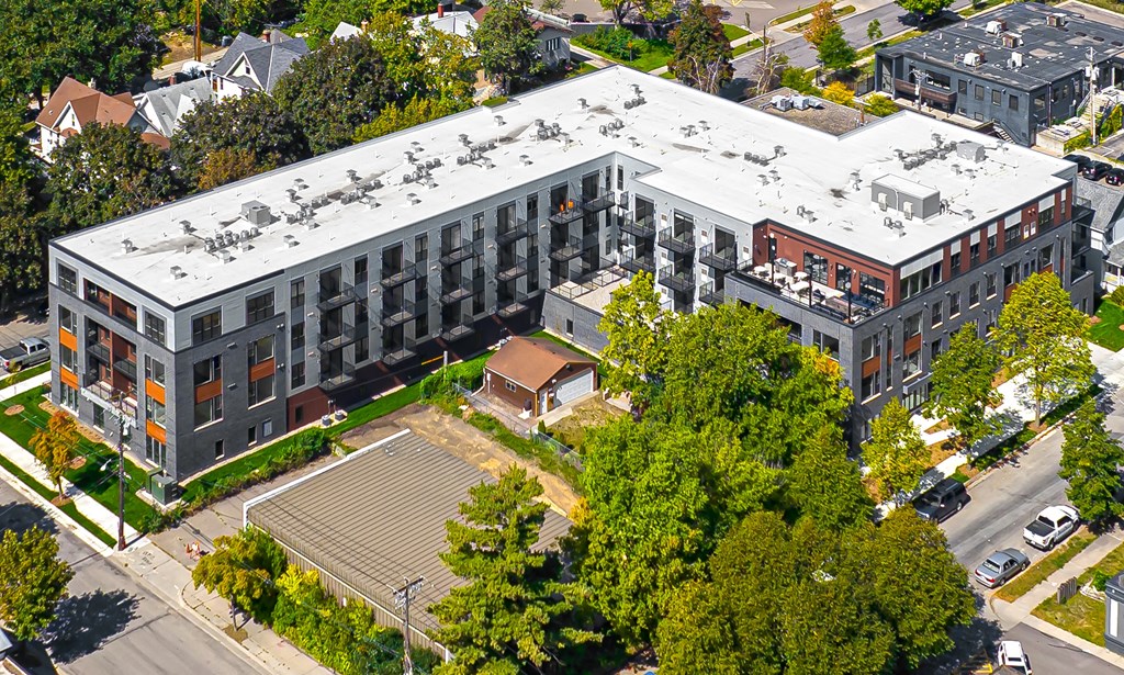 an aerial view of a large building with a white roof
