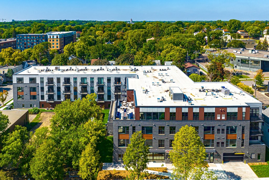 an aerial view of a building surrounded by trees and other buildings