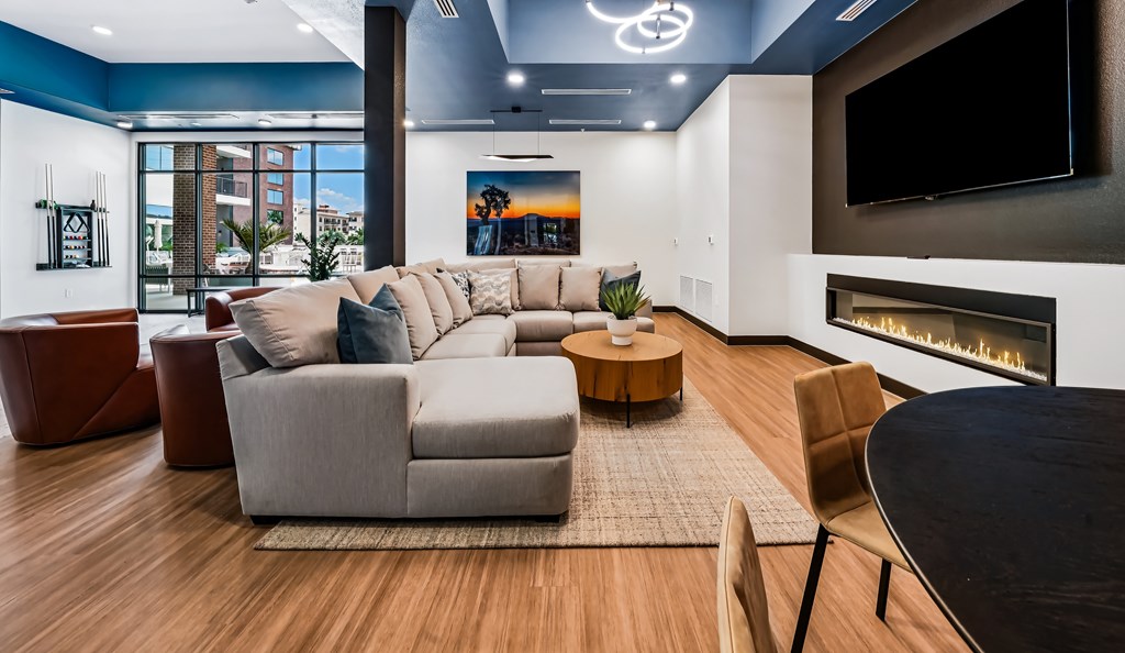 A modern living room with a fireplace and a large couch.