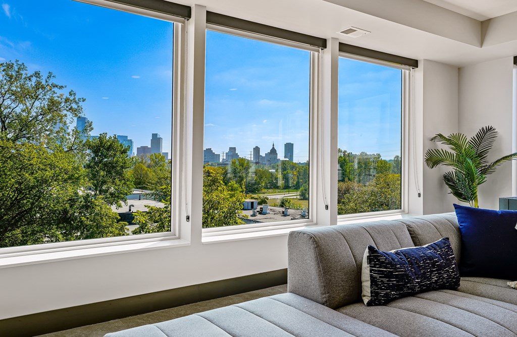 a living room with a couch and a view of the city