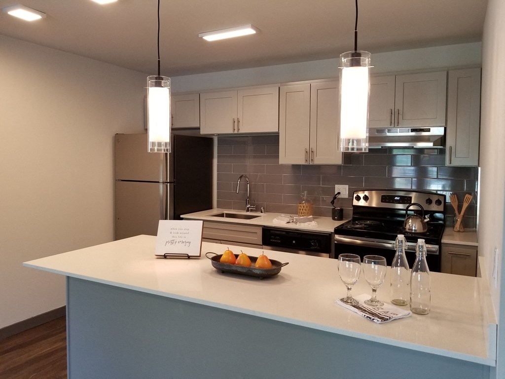 a kitchen with a counter with a bowl of fruit on it